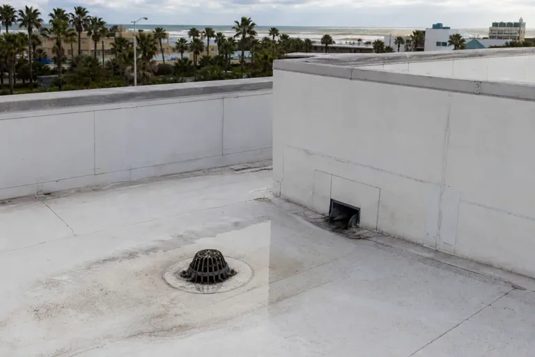 Low-slope roof drain area with ponding water concern on a commercial building